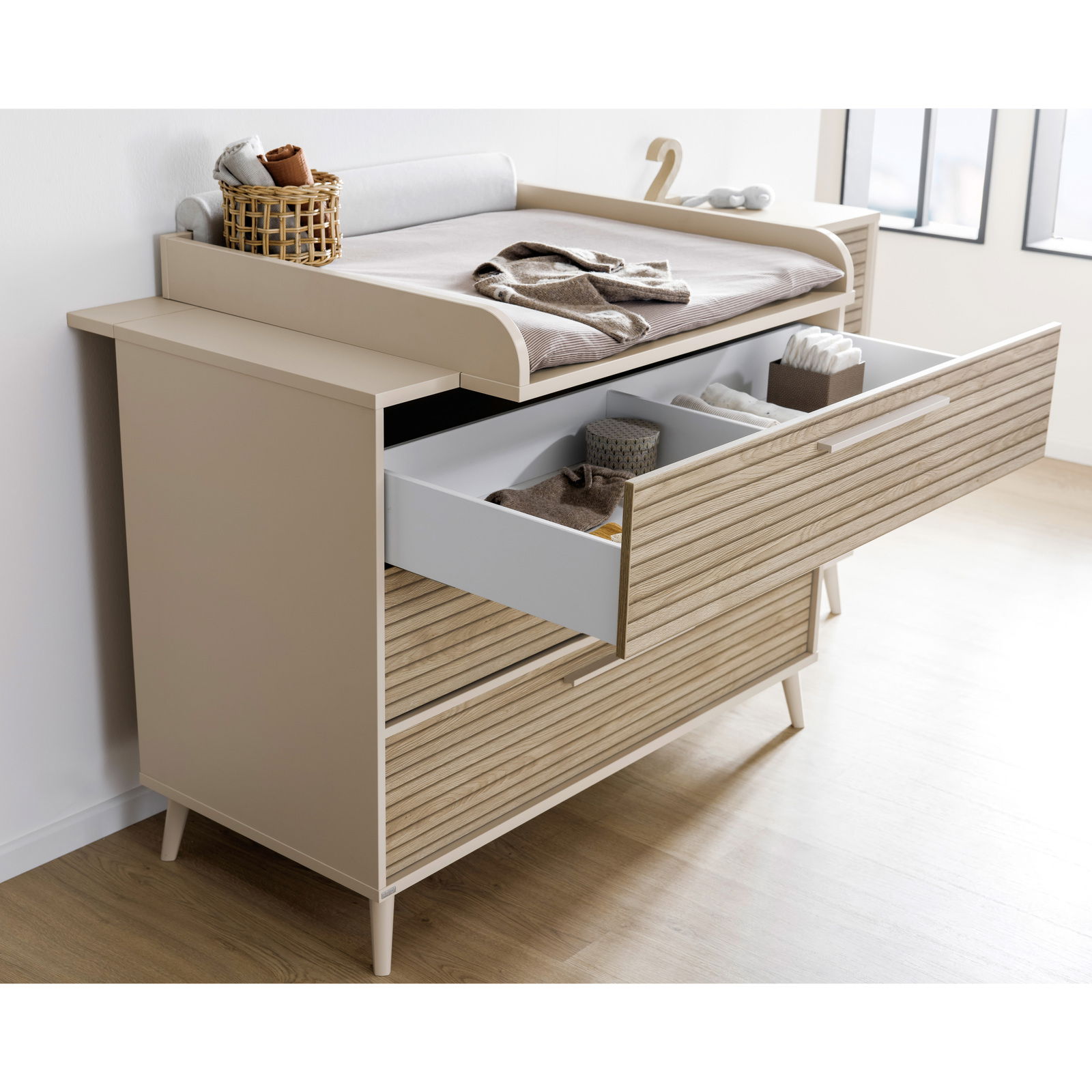 Paidi Wickelaufsatz breit EEFJE Wickelaufsatz breit auf einer Kommode mit geöffneten Schubladen, seitliche Perspektive