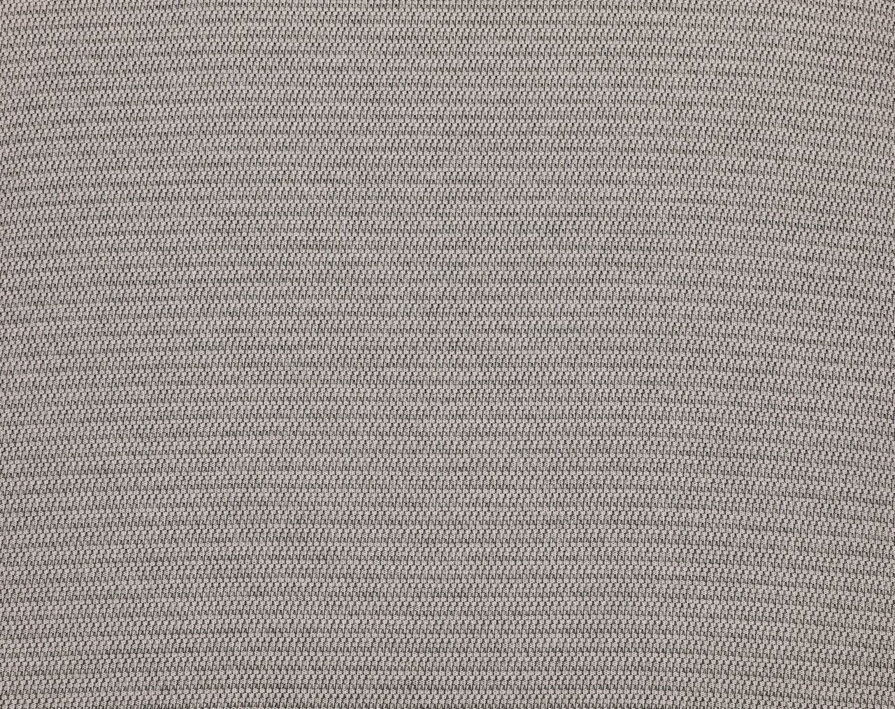 Nahaufnahme einer grauen, strukturierten Stoffoberfläche, von oben betrachtet.