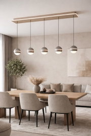 Moderne LED-hanglamp met vijf bolvormige lampen, hangend boven een eettafel in een stijlvol ingerichte woonkamer, gezien vanaf de zijkant.