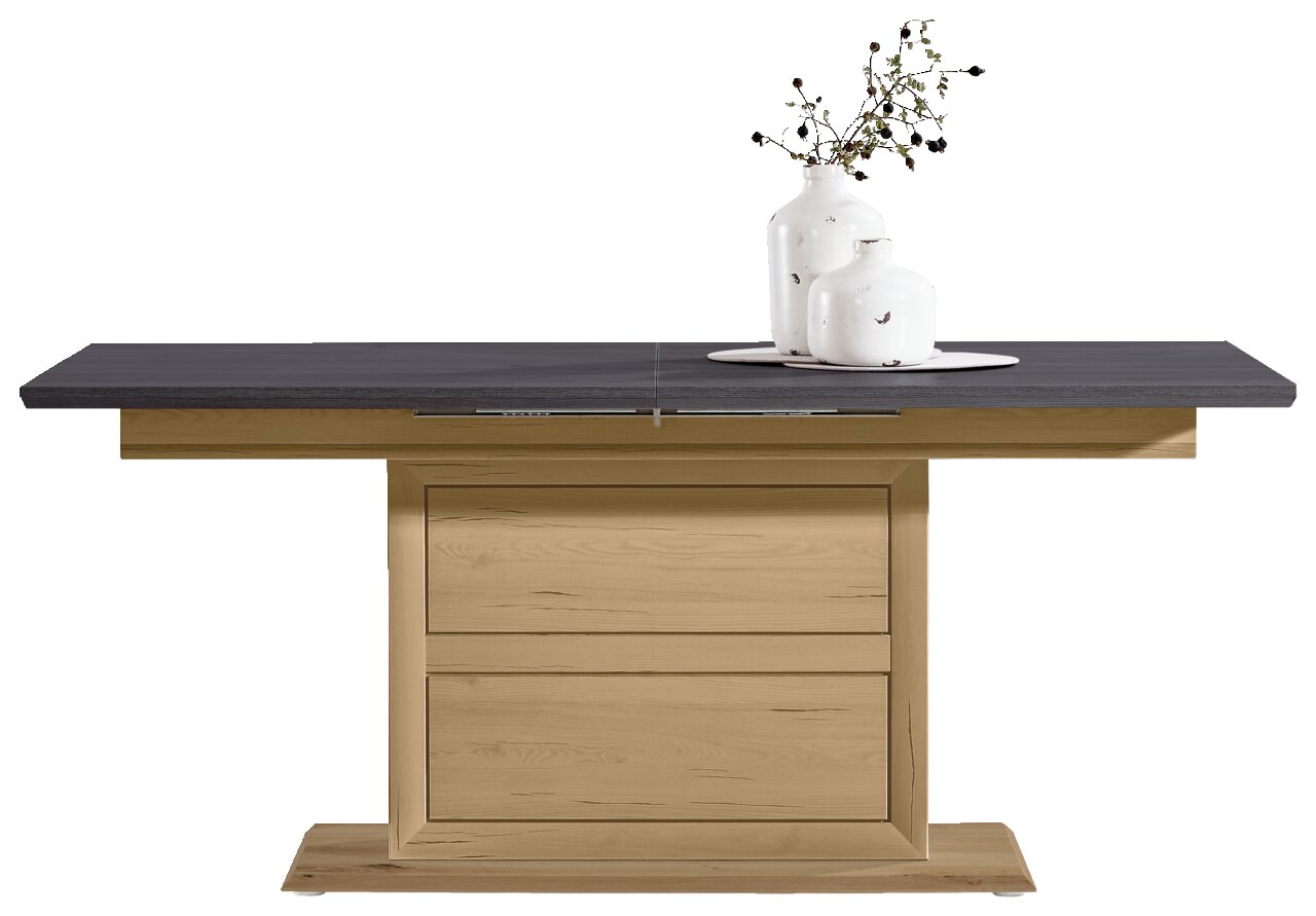 Moderne functionele eettafel met een donker tafelblad en een licht houten onderstel, hier van voren afgebeeld, versierd met twee witte vazen.