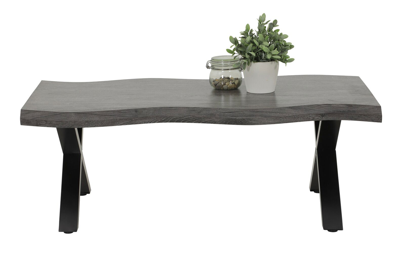 Moderner Couchtisch mit wellenförmiger grauer Tischplatte und schwarzen Metallbeinen, frontal fotografiert. Dekoriert mit einer Pflanze und einem Glasgefäß.