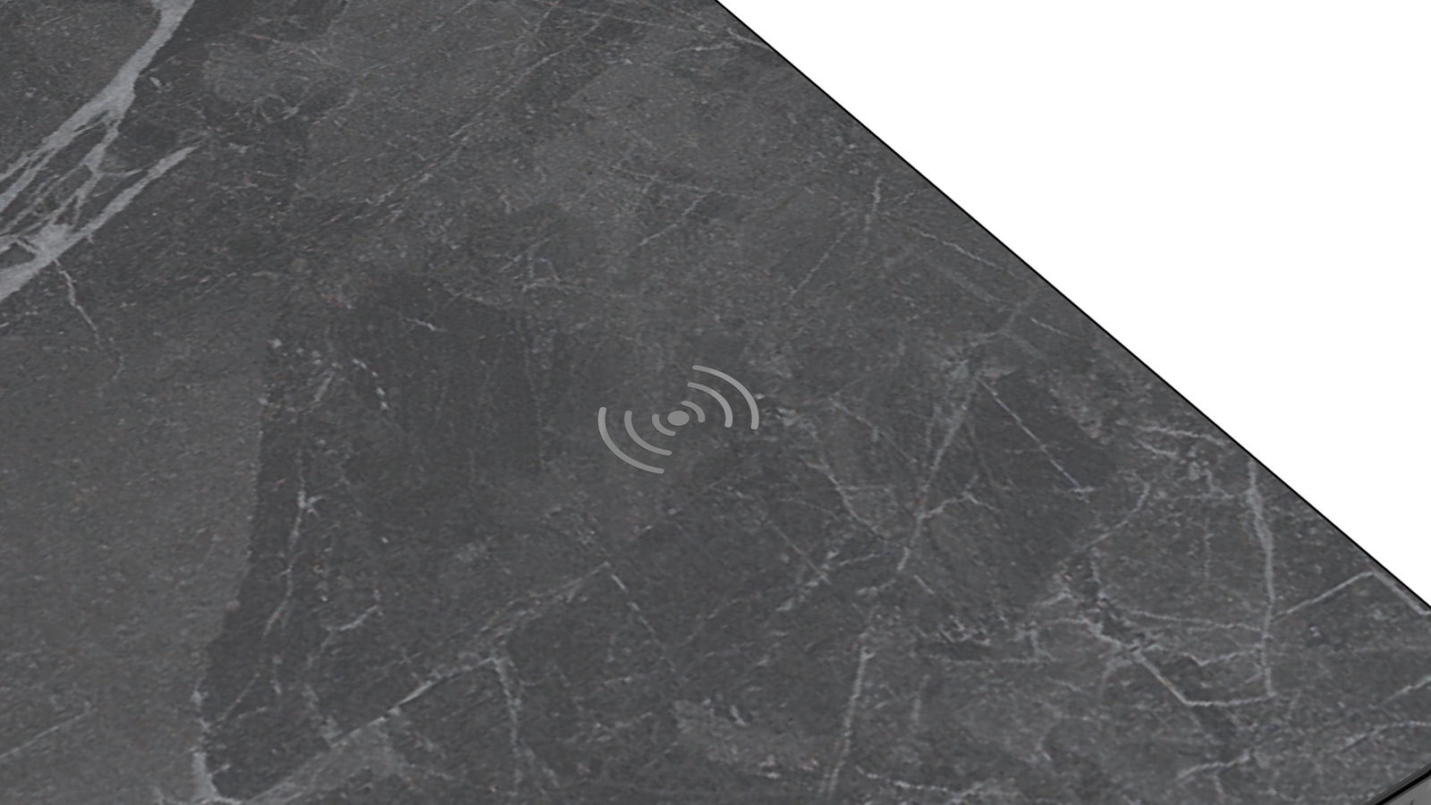 Draufsicht auf eine dunkle Tischplatte mit integriertem kabellosen Ladegerät.