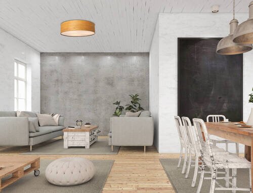 Moderne Deckenleuchte in einem stilvoll eingerichteten Wohnzimmer aus der Perspektive des Essbereichs betrachtet.