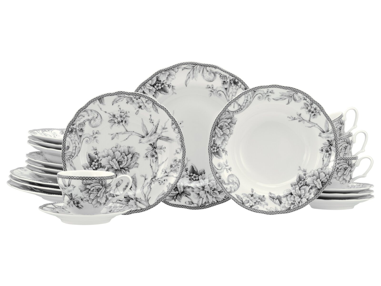Schwarz-weißes Porzellan-Geschirrset mit floralen Motiven und Vogelillustration, bestehend aus Tellern, Schalen und Tassen, frontal in leicht schräger Perspektive auf weißem Hintergrund präsentiert.