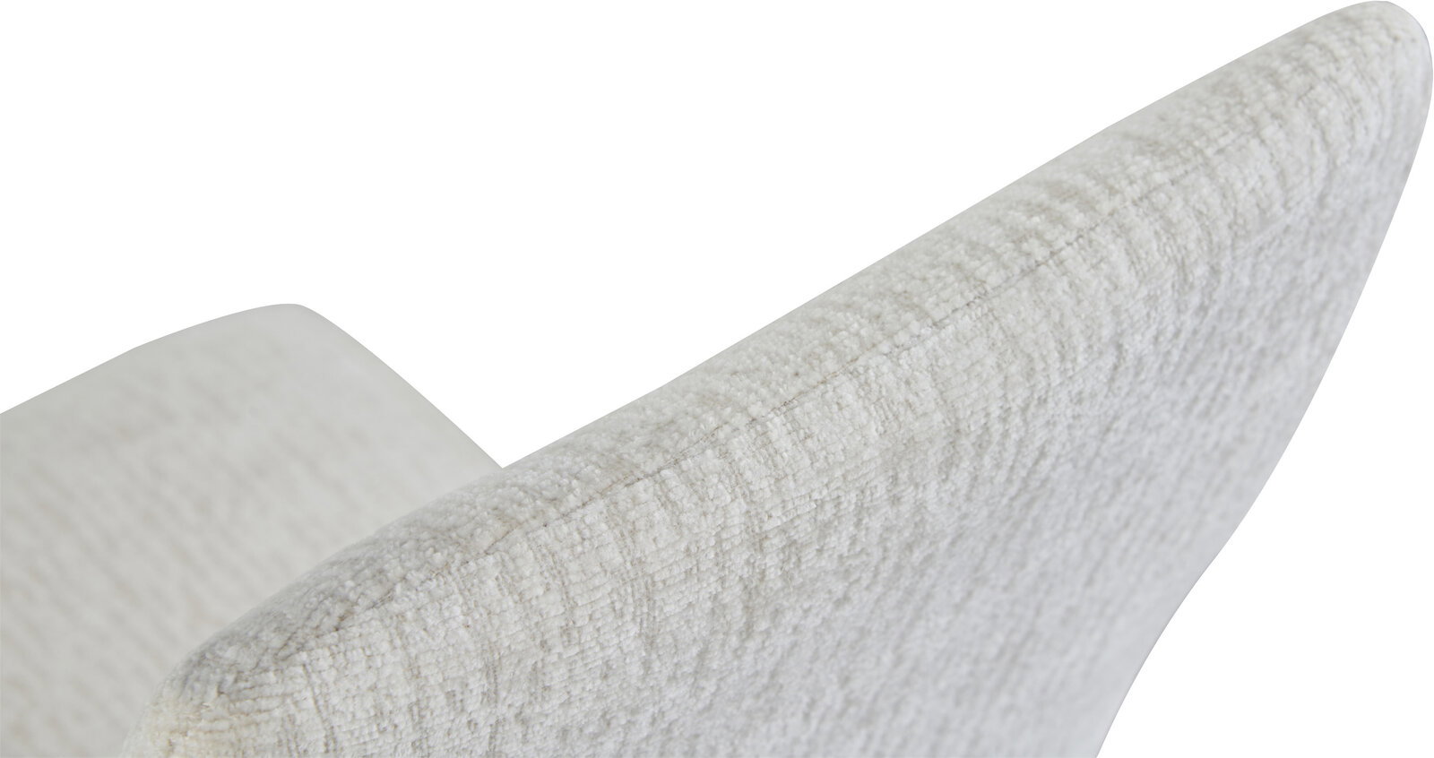 Nahaufnahme eines hellen, strukturierten Polsterkissens mit abgerundeter Kante, schräg von oben fotografiert