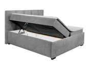 Graues Polsterbett mit hochgeklappter Matratze und sichtbarem Stauraum, seitliche Perspektive