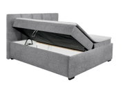 Grijs boxspringbed met opklapbaar matras en zichtbare opbergruimte, zijaanzicht