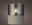 LED Kerze in einem zylindrischen Glas mit Wachsfuß, seitliche Perspektive