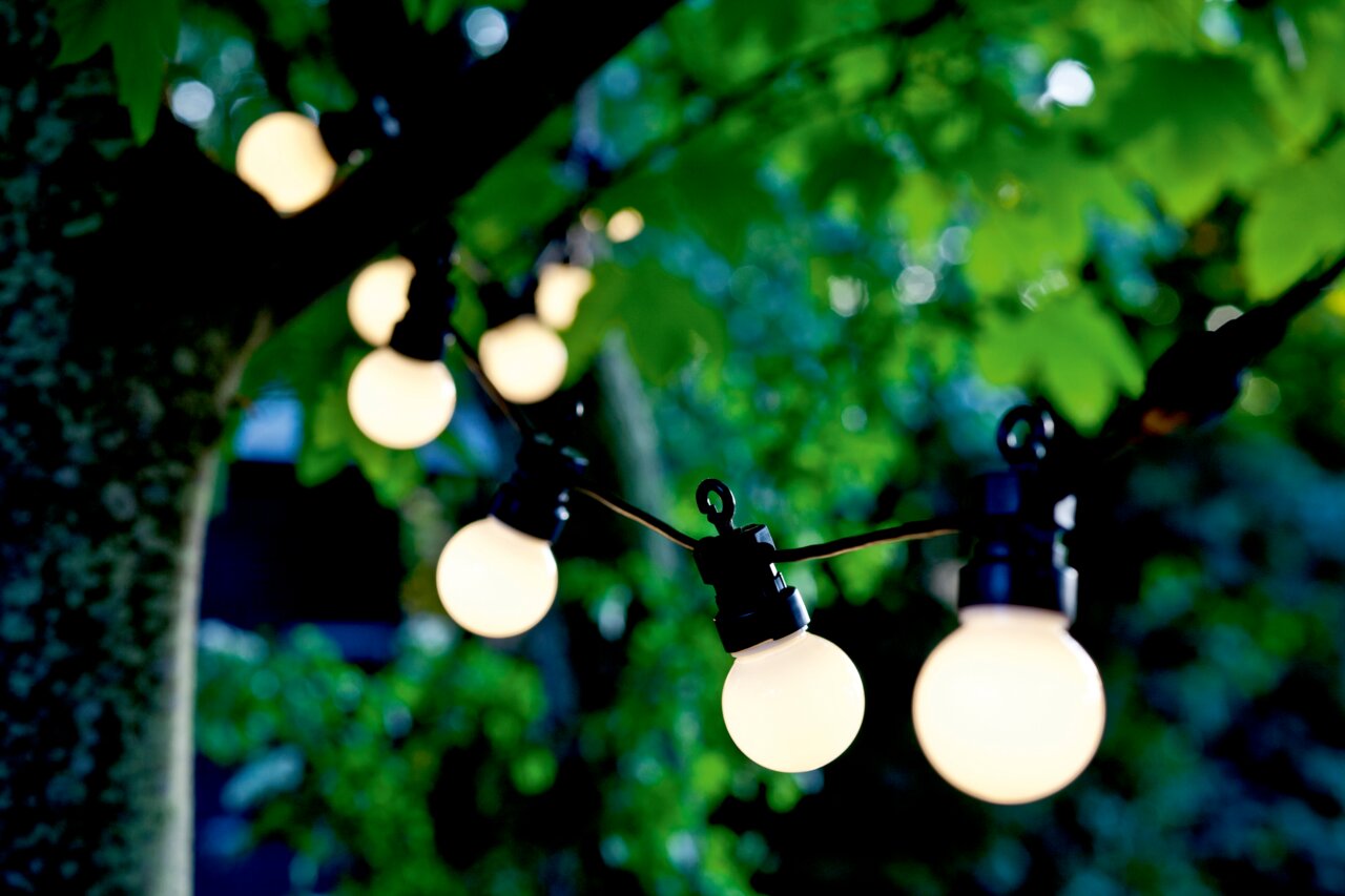 Sirius Solar Lichterkette Erweiterung LUCAS Solarbetriebene Lichterkette mit 10 LED-Lampen, aufgehängt in einem Baum, aus der Nähe betrachtet.