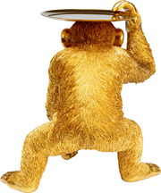 Goldene Deko-Figur eines sitzenden Schimpansen von hinten, der ein Tablett auf dem Kopf balanciert.