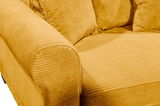 Nahaufnahme eines gelben Funktionssofas mit geripptem Stoffbezug, Blick auf die Armlehne und Sitzfläche.