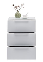 Weiße Nachtkonsole mit drei Schubladen, darauf eine grüne Vase mit Zweigen und eine weiße Tasse mit Löffel, frontale Ansicht.