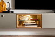 Moderne Wandkombination mit integriertem Regal, Glasboden und Beleuchtung, seitliche Perspektive