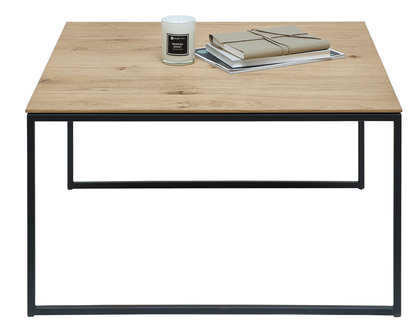 Moderner Beistelltisch mit Holzplatte und schwarzem Metallgestell, frontal fotografiert. Auf dem Tisch stehen eine Kerze und Bücher.