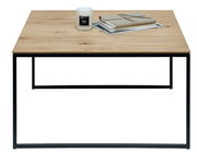 Moderner Beistelltisch mit Holzplatte und schwarzem Metallgestell, frontal fotografiert. Auf dem Tisch stehen eine Kerze und Bücher.