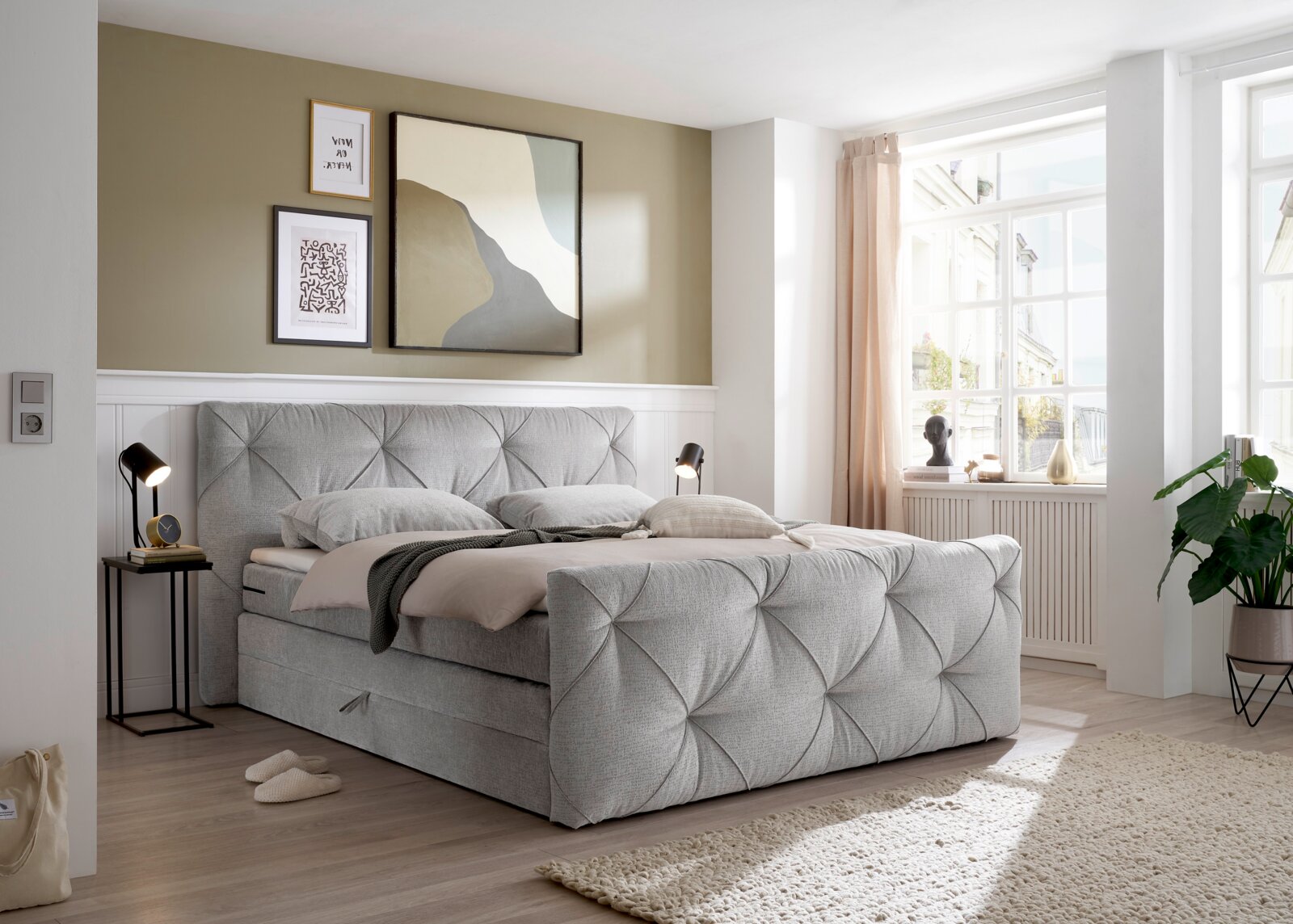 Grijs boxspringbed in een moderne slaapkamer, zijaanzicht