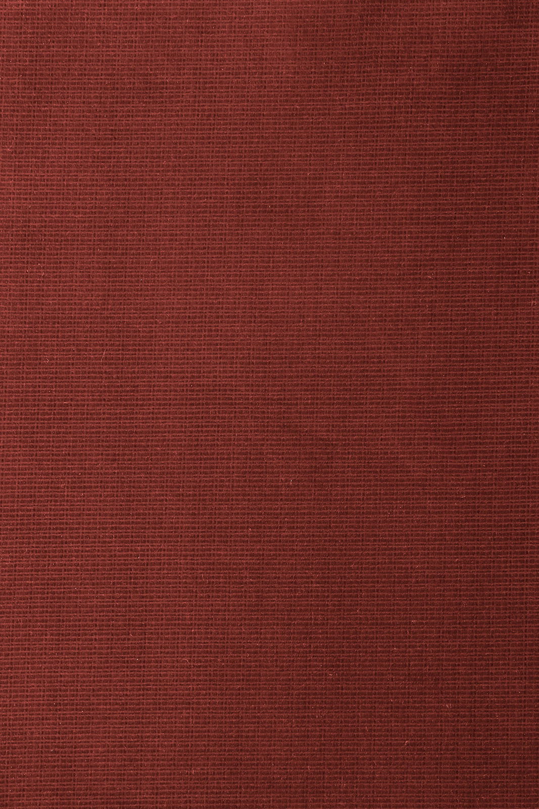 Nahaufnahme eines roten Stoffes mit feiner Textur, von oben betrachtet.