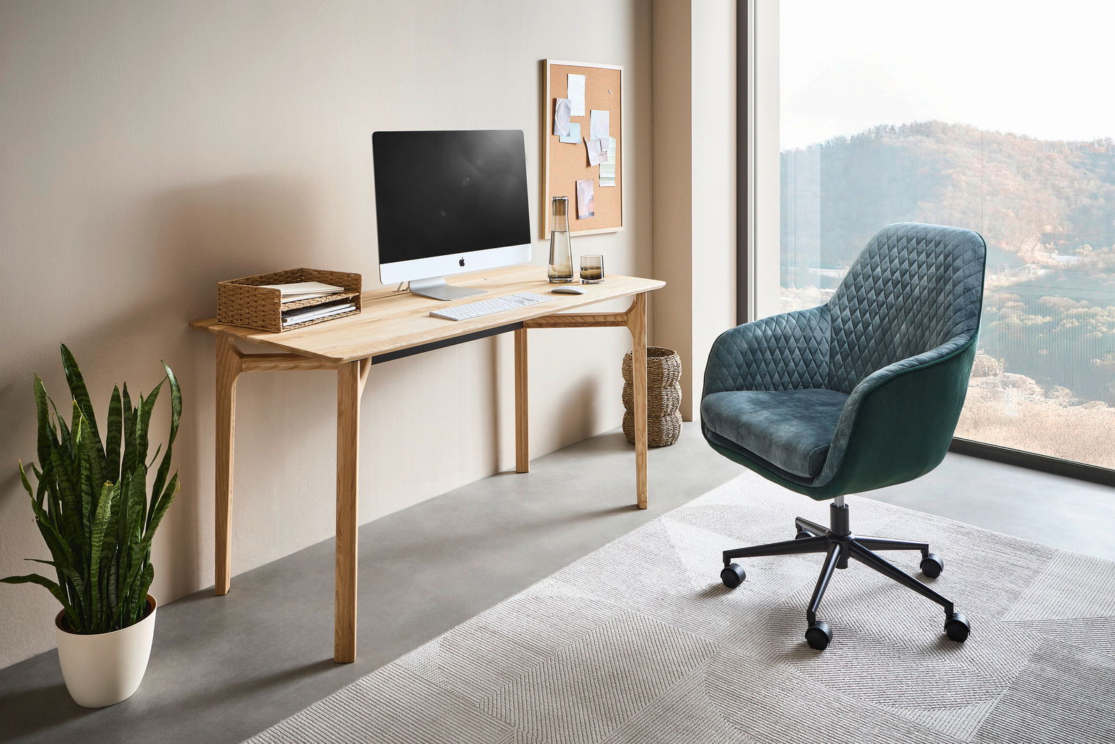 Linea Natura Schreibtisch SOPHIA Moderner Schreibtisch aus Holz mit Computer, Pflanzen und einem bequemen Bürostuhl in einem hellen Raum mit Blick auf die Landschaft, seitliche Perspektive.