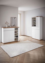 Moderner Schuhschrank in Weiß mit Holzdetails, offene Türen zeigen mehrere Regalböden mit Schuhen, seitliche Perspektive.