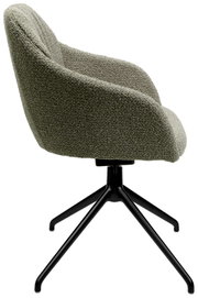 Zijaanzicht van een fauteuil met groene stoffen bekleding en een zwart metalen frame.