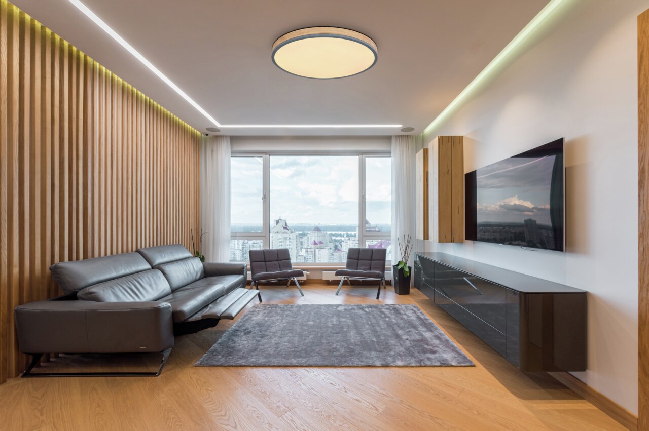 Moderne Deckenleuchte DORO in einem stilvollen Wohnzimmer, von unten betrachtet.