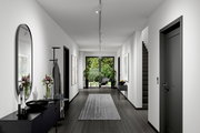 Moderner Flur mit Schienenspot Tubo an der Decke, Blick in Richtung Garten durch Glastüren.