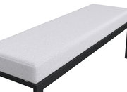 Seitliche Ansicht einer modernen Gartenbank mit weißem Polster und schwarzem Metallrahmen.