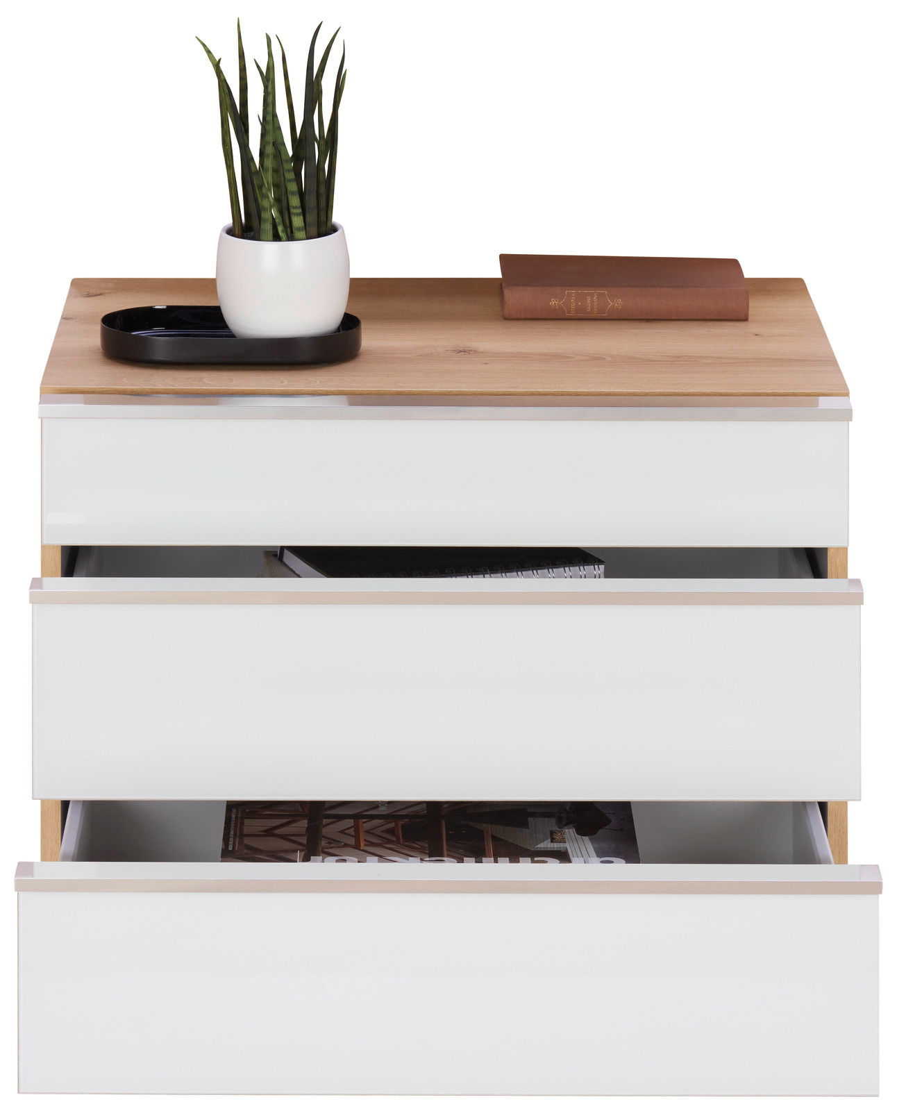 Nachtschrank-Set mit drei offenen Schubladen, darauf eine Pflanze in einem weißen Topf und ein Buch. Frontalansicht.
