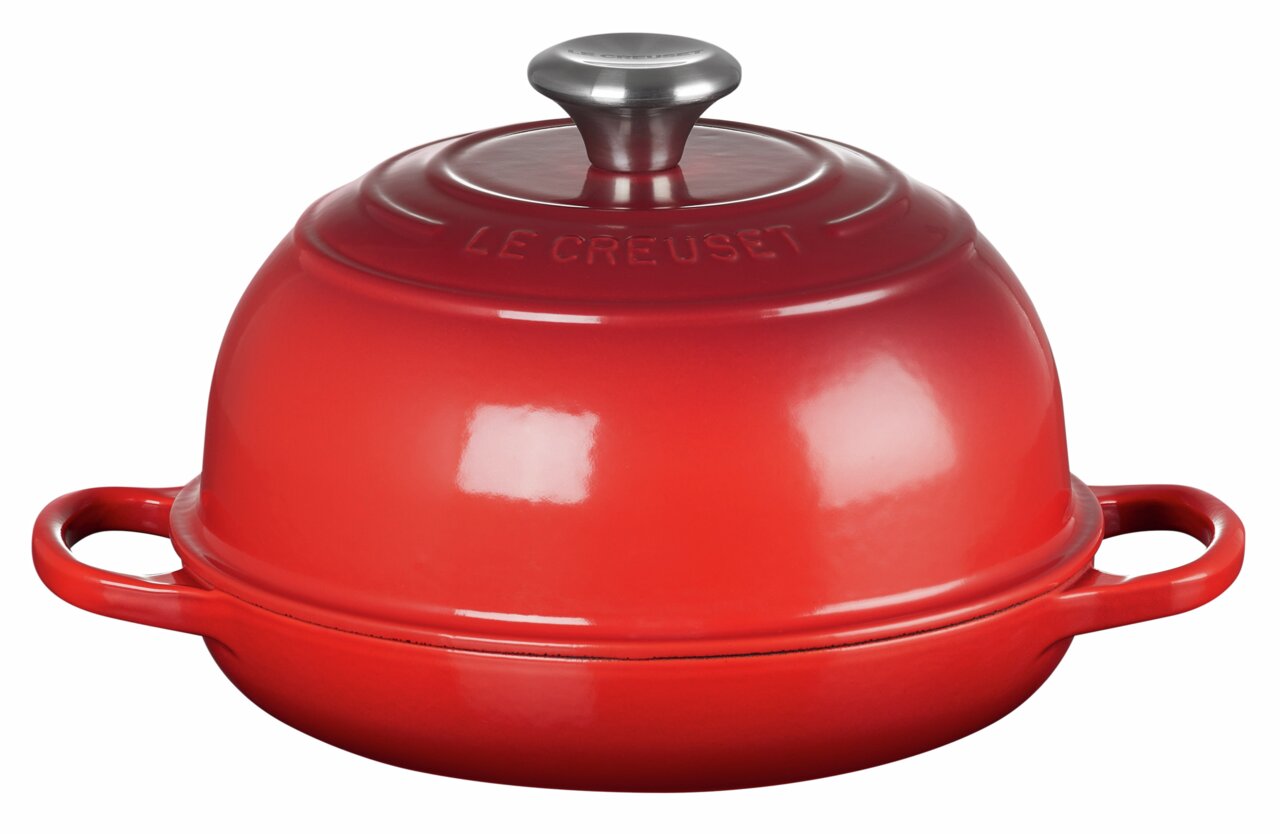 Roter Brot Bräter von Le Creuset, seitliche Perspektive, mit zwei Griffen und einem Deckel mit Metallknauf.