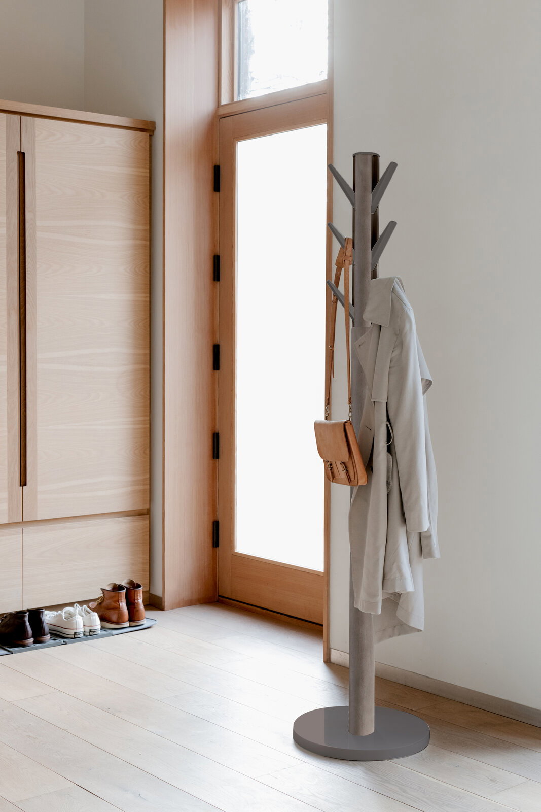 Moderner Garderobenständer aus Metall in einem hellen Flur, seitliche Perspektive