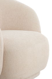 Nahaufnahme eines beigen, gepolsterten Stuhls mit abgerundeten Formen, seitliche Perspektive