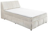 Beiges Boxspringbett mit gepolstertem Kopfteil, seitliche Perspektive
