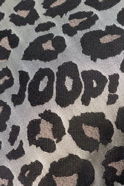 Nahaufnahme einer Zierkissenhülle mit Leopardenmuster und dem Schriftzug 'JOOP!' in der Mitte.