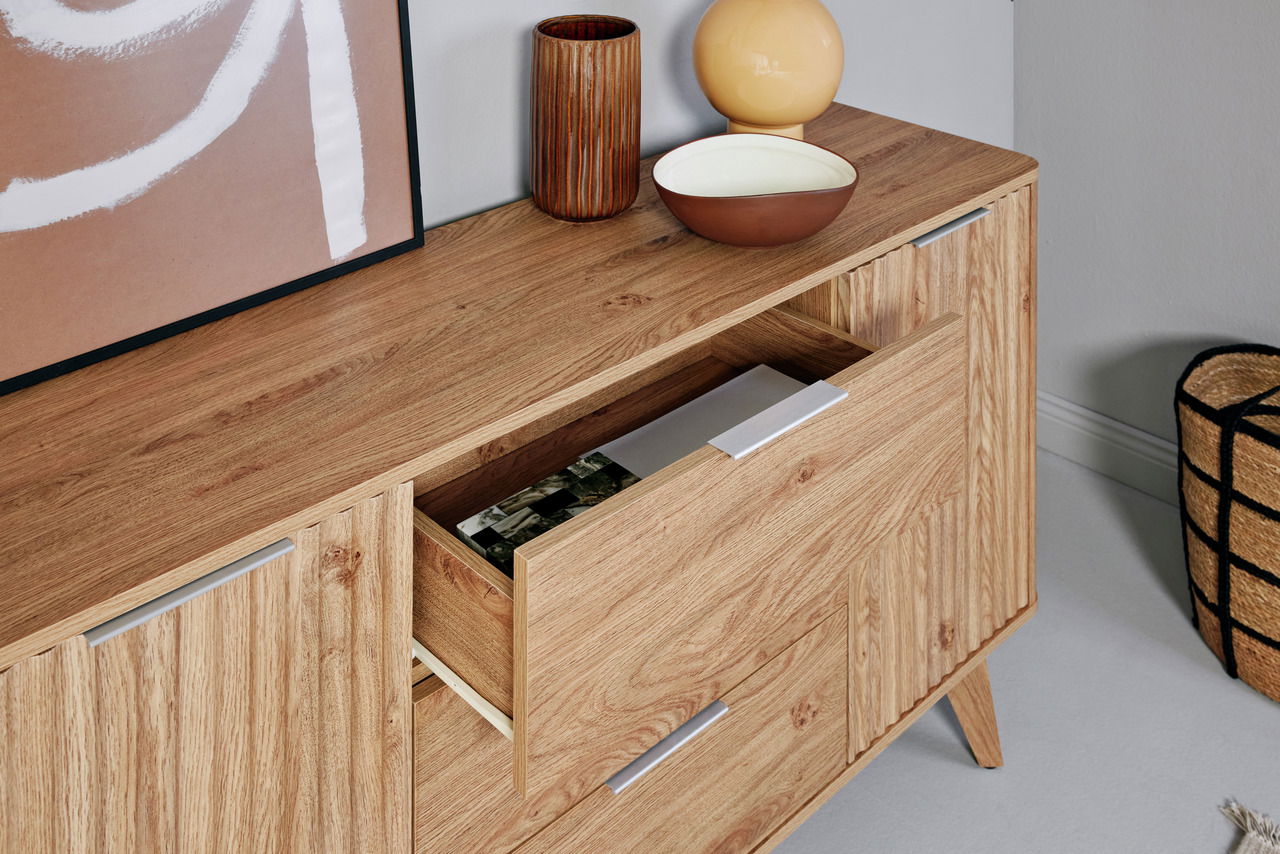 Holz-Sideboard mit Schubladen, dekoriert mit Vasen und Schalen, aus seitlicher Perspektive