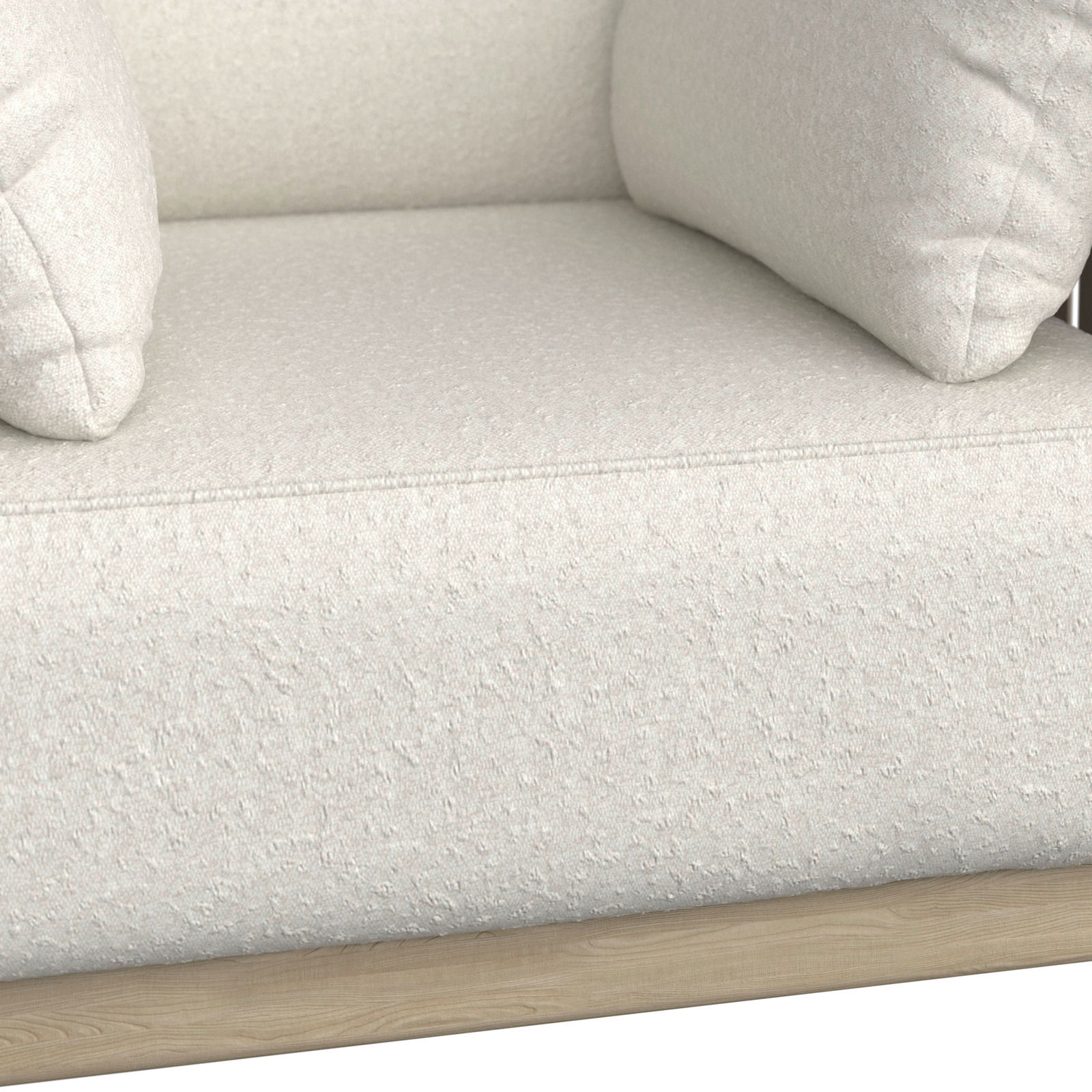 Nahaufnahme eines cremefarbenen Loungesessels mit weicher Polsterung und Holzrahmen, seitliche Perspektive