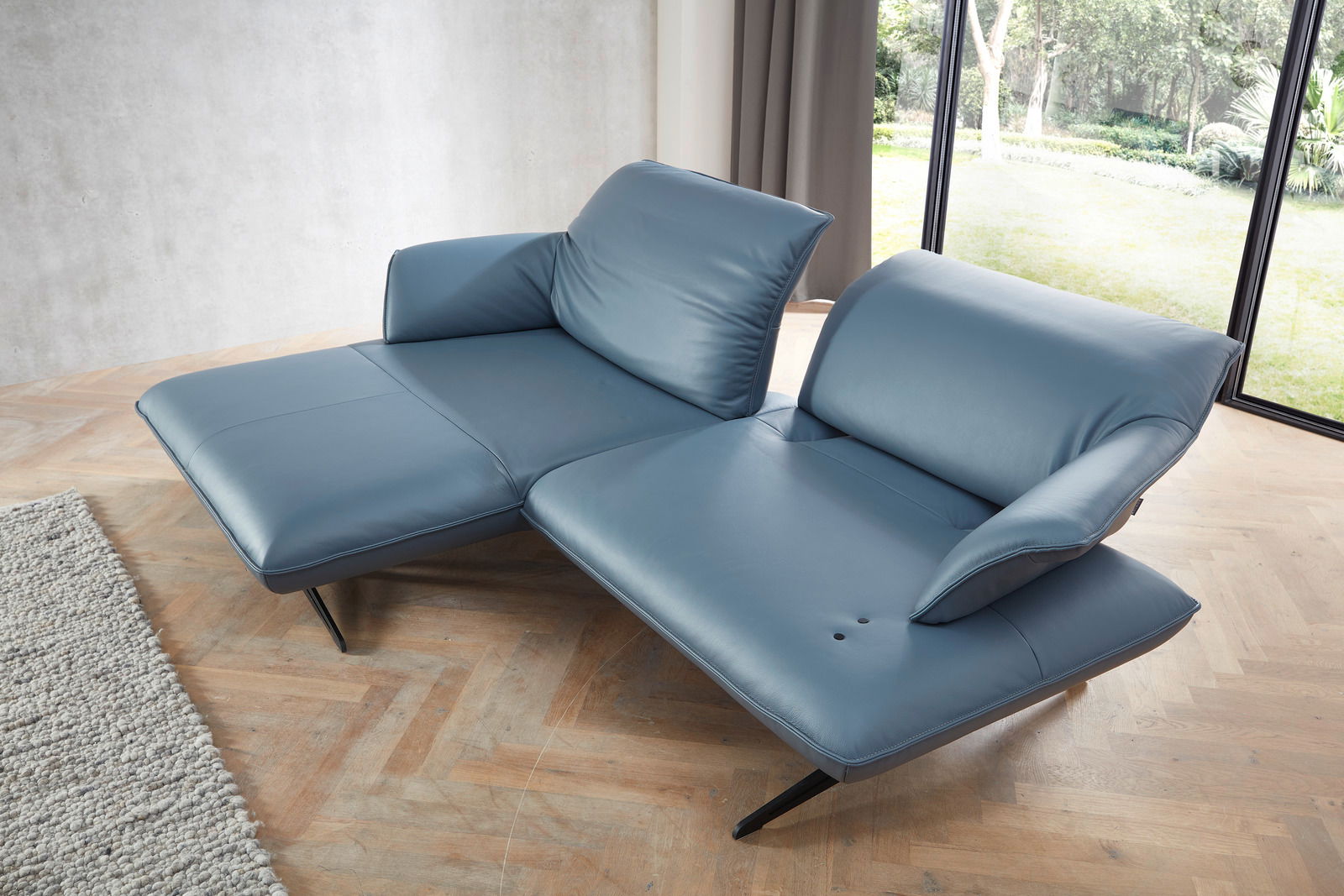 Koinor Longchairkombination SEVENTY Blaue Longchairkombination Koinor SEVENTY in moderner Wohnzimmerumgebung, seitliche Perspektive mit Blick auf die Fensterfront.