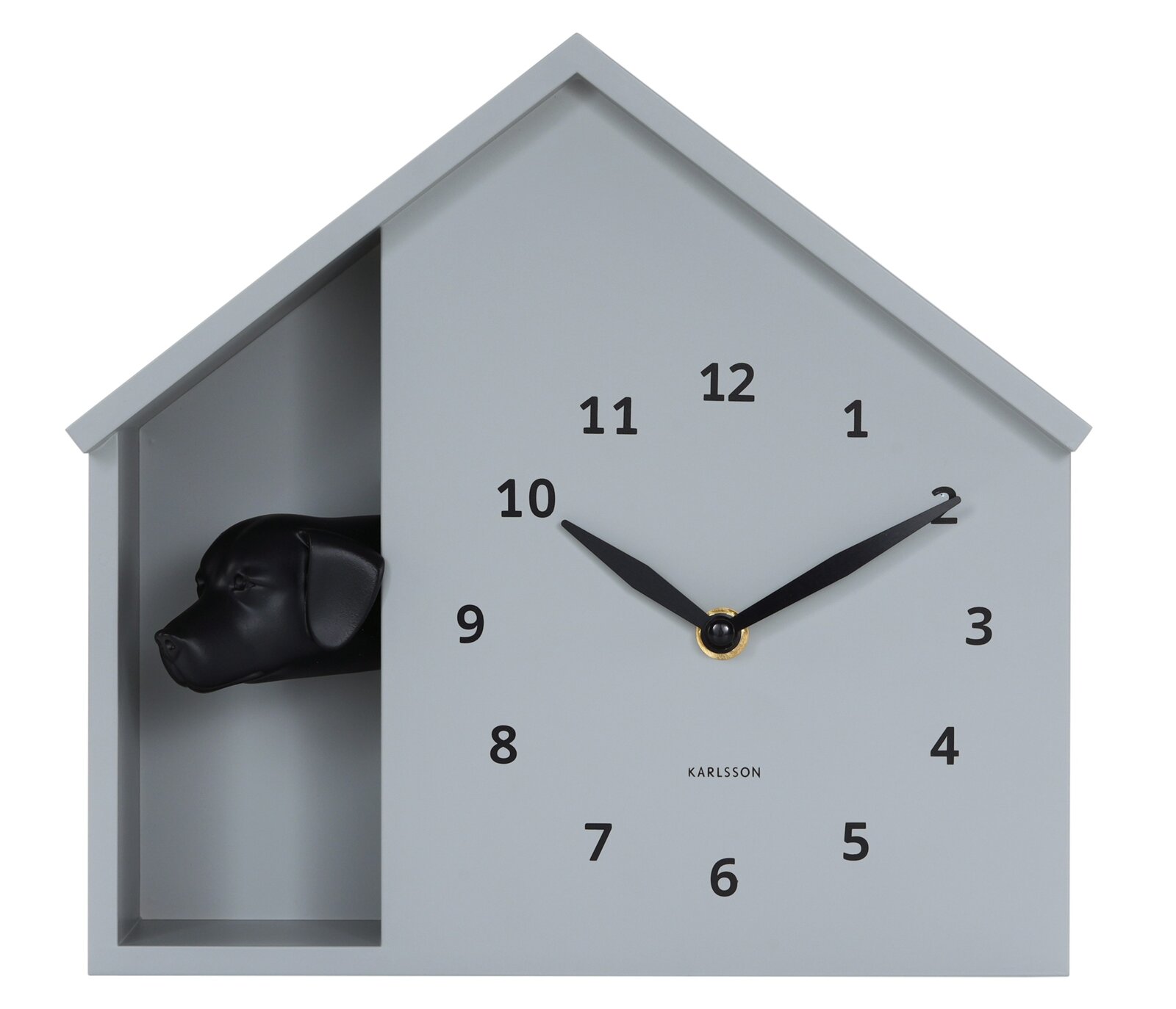 Moderne wandklok in de vorm van een huis met een zwarte hondenkop, van voren afgebeeld.