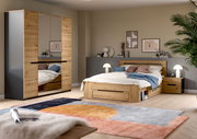 Modernes Schlafzimmer-Set in Holzoptik mit Bett inklusive Stauraum, Nachttisch und großem Kleiderschrank mit Spiegeltüren, aufgenommen in schräger Frontansicht aus leicht erhöhter Perspektive.