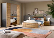 Modernes Schlafzimmer-Set in Holzoptik mit Bett inklusive Stauraum, Nachttisch und großem Kleiderschrank mit Spiegeltüren, aufgenommen in schräger Frontansicht aus leicht erhöhter Perspektive.