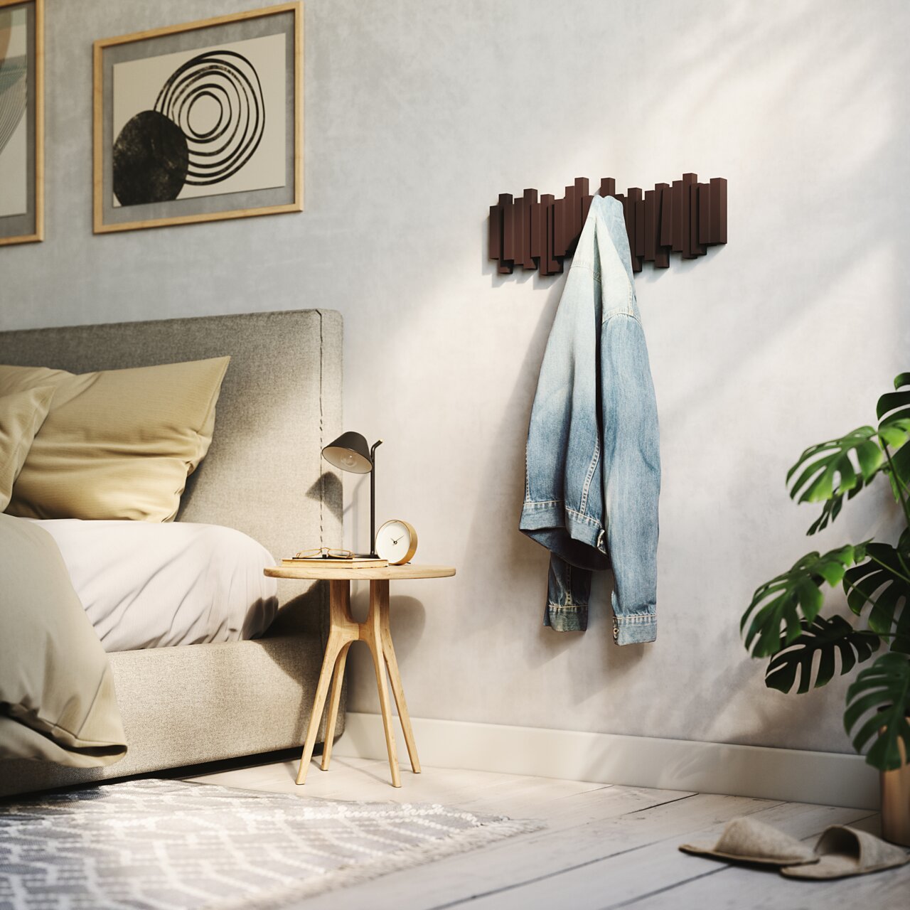 Umbra Wandkapstok STICKS Moderne Wandgarderobe in einem stilvollen Schlafzimmer, frontal betrachtet, mit einer aufgehängten Jeansjacke.
