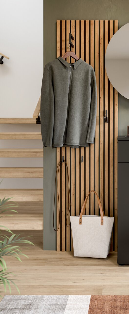 Garderobenpaneel aus Holz mit Haken, an dem ein grauer Mantel hängt. Perspektive von vorne.