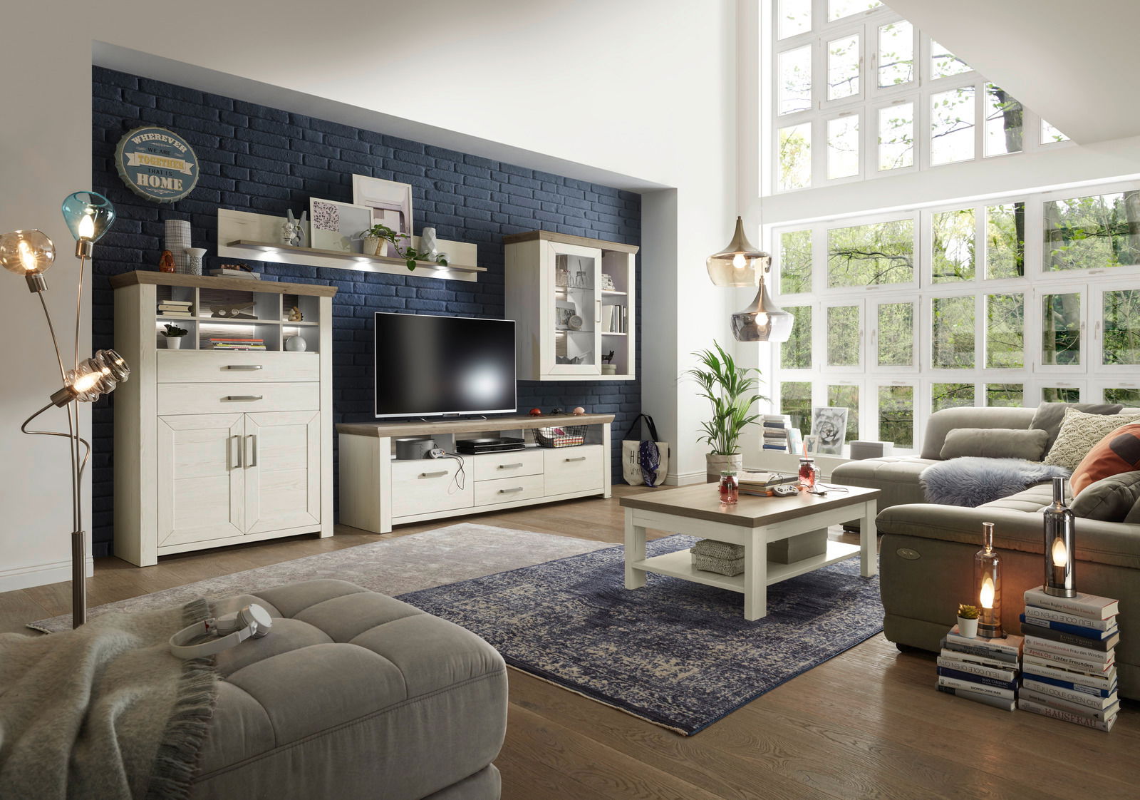 Wohnzimmer mit moderner Wohnwand, bestehend aus Highboard, Lowboard, Hängeelement und Wandboard, in heller Holzoptik. Perspektive von der Seite mit Blick auf die gesamte Einrichtung.