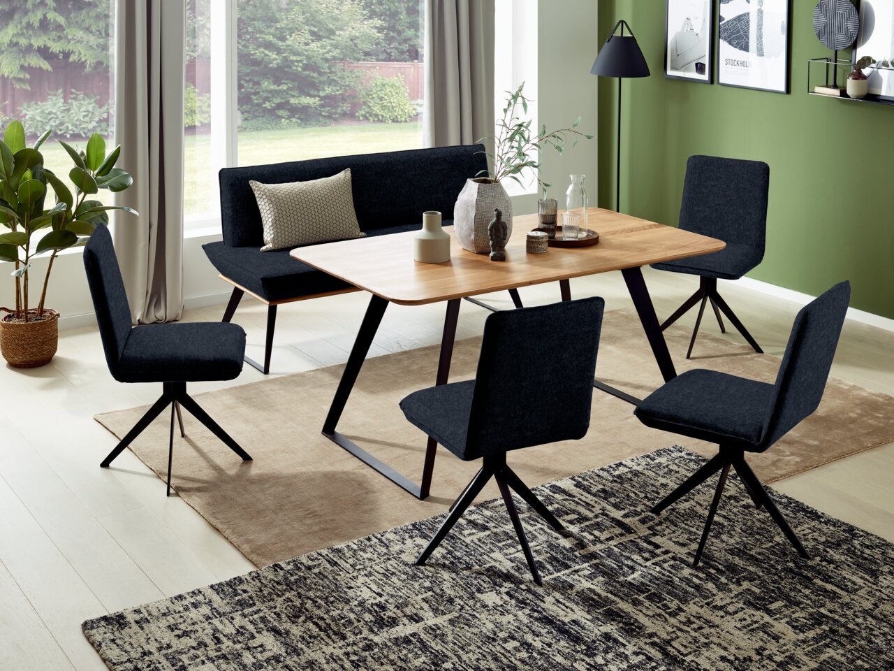 Voleo Bank 180 cm MALIBU Esszimmer mit modernem Tisch und Bank in Holzoptik, umgeben von vier schwarzen Stühlen, aus der Vogelperspektive betrachtet.
