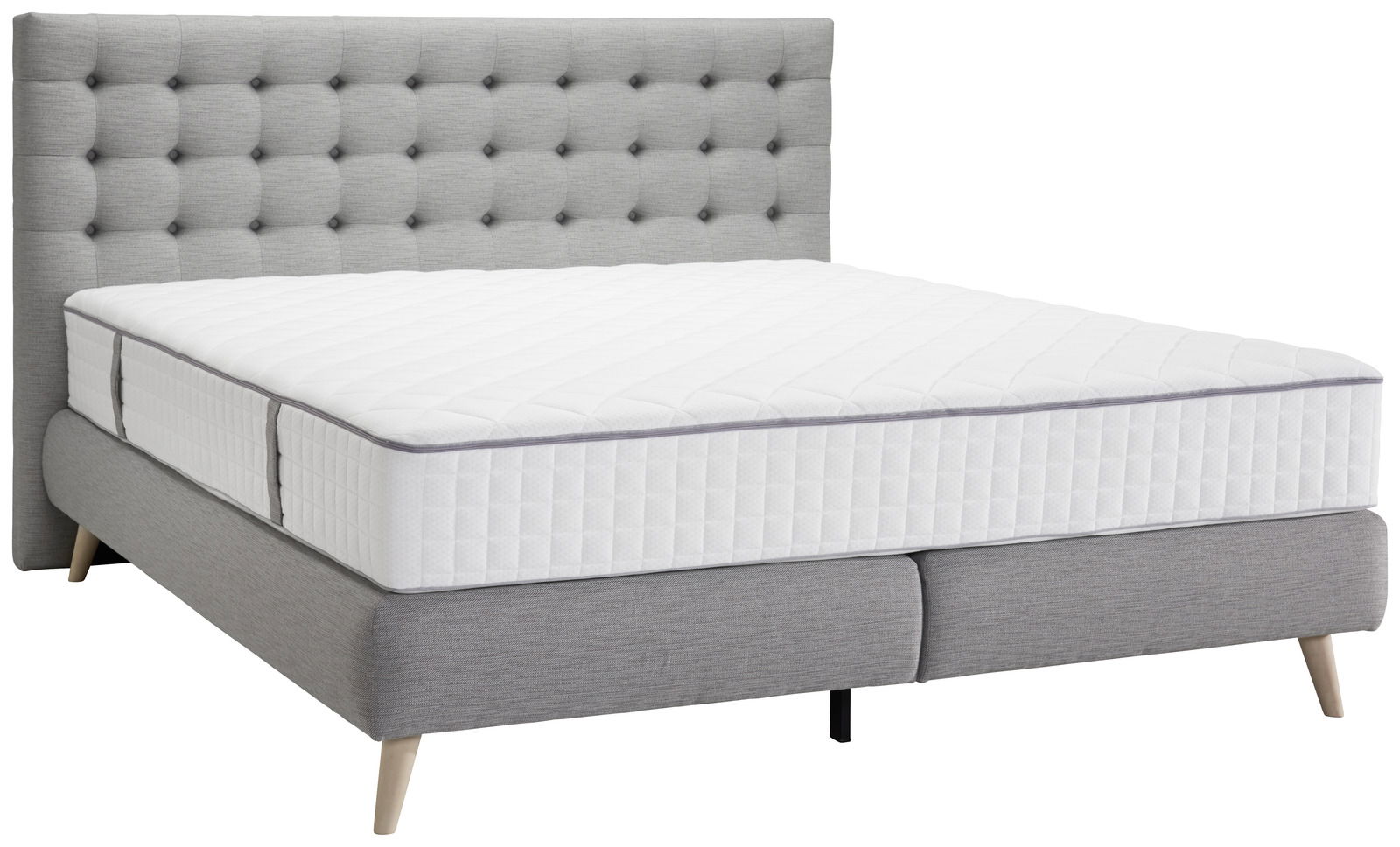 Graues Boxspringbett mit gestepptem Kopfteil und weißer Matratze, seitliche Perspektive