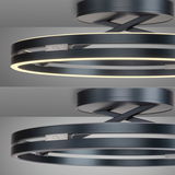 Moderne Deckenleuchte PURE Loop von Paul Neuhaus in schwarzem Metall mit zwei leuchtenden Ringen, seitliche Perspektive.