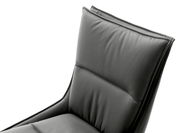 Nahaufnahme eines modernen, gepolsterten Stuhls in dunklem Leder, Ansicht von der Seite