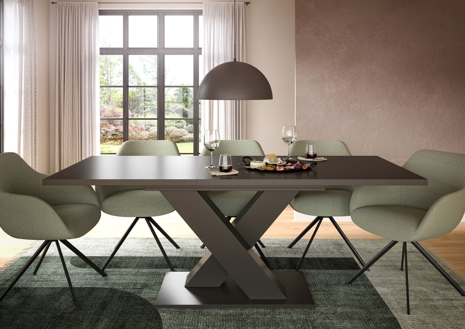 MID.YOU Esstisch MOTION Moderner Esstisch mit X-förmigem Gestell, umgeben von grünen Stühlen, in einem hellen Raum mit großem Fenster, aus der Frontalperspektive.