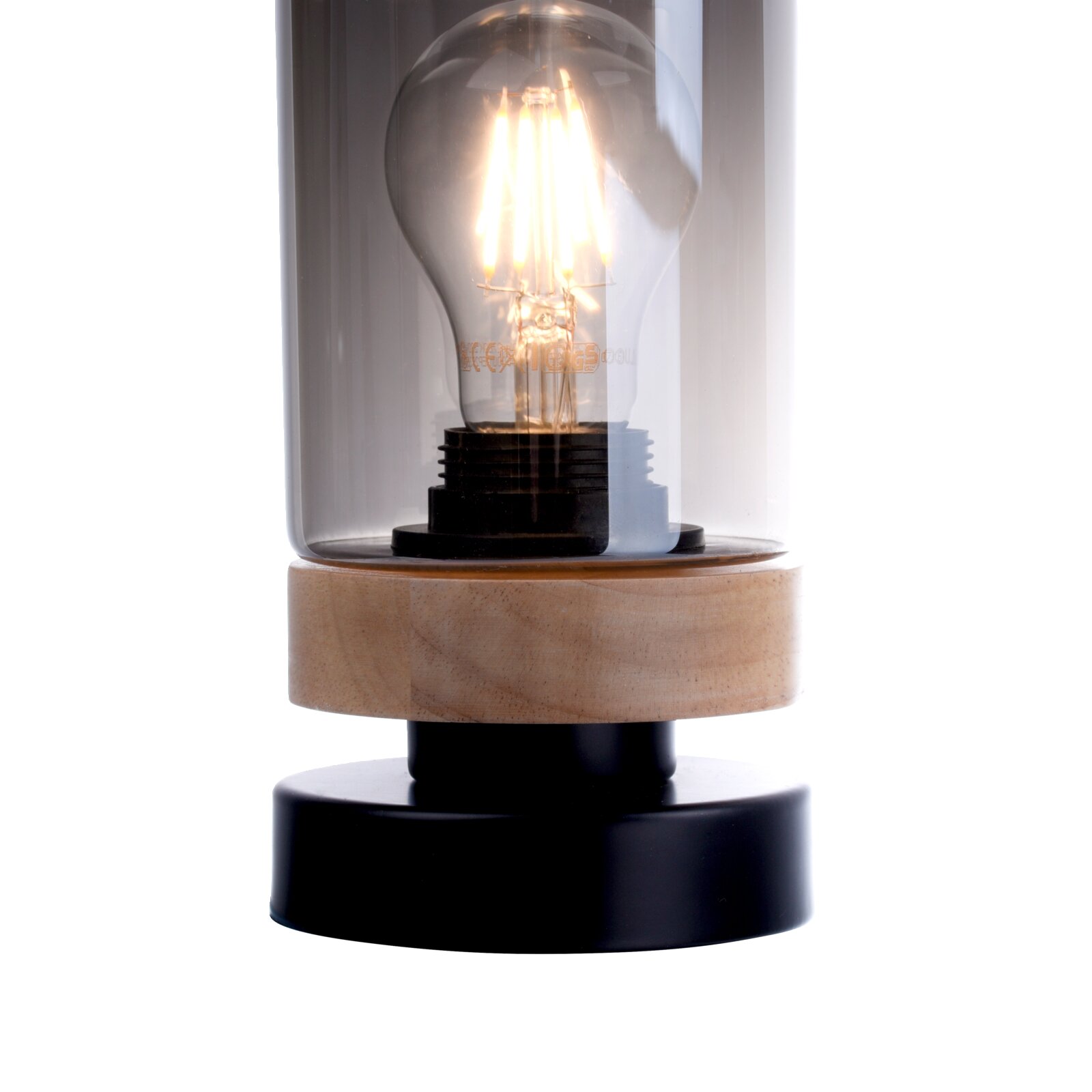 Nahaufnahme einer dekorativen Tischlampe mit leuchtender LED-Filament-Glühbirne unter klarem Glaszylinder, Holzring und schwarzem Sockel, frontale Perspektive