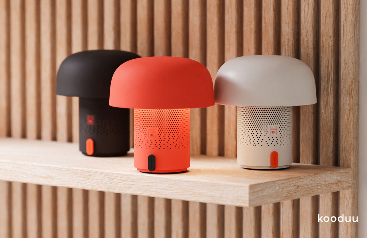 kooduu AKKU-Tischleuchte &JBL-Speaker SENSA PLAY MINI JBL Drei Sensa Play Mini JBL Akku-Tischleuchten in Schwarz, Rot und Beige auf einem Holzregal, seitliche Perspektive.