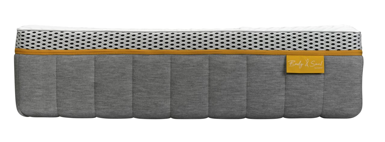 Seitenansicht einer grauen Matratze mit weißem und gelbem Akzent, Modell BODY&SOUL von irisette.
